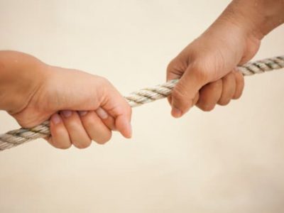 fight of two hands pulling rope to each other